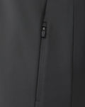 Detail of the branded quarter zip on the gunmetal sweatshirt with visible zipper pull and fabric texture.