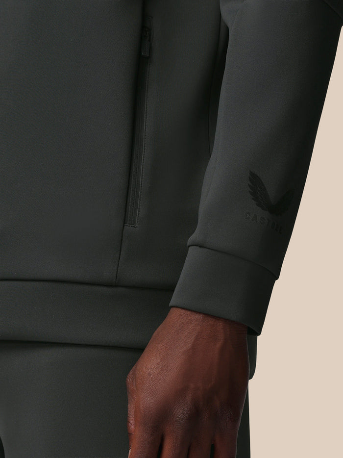 Close-up of sleeve cuff on gunmetal sweatshirt showing the Castore wing logo