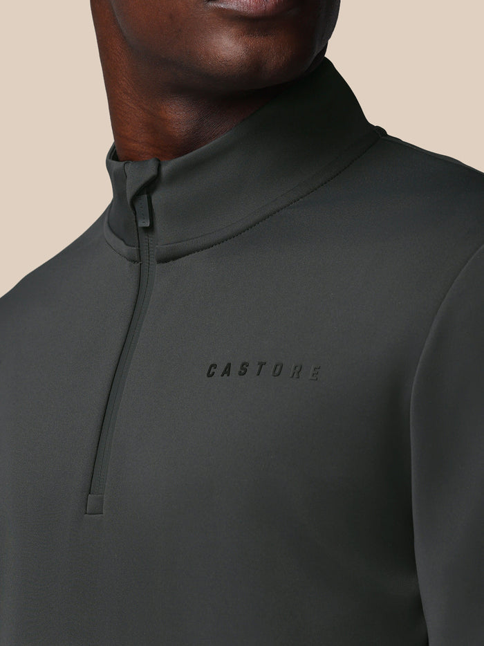 Close up of gunmetal Heren Flex sweatshirt showing Castore logo on the left chest and a quarter zip.