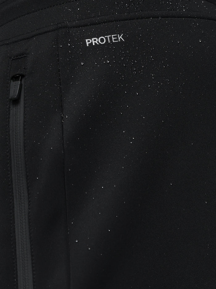 Close-up of black Flex Joggers fabric with ProTek branding and a zipper pull