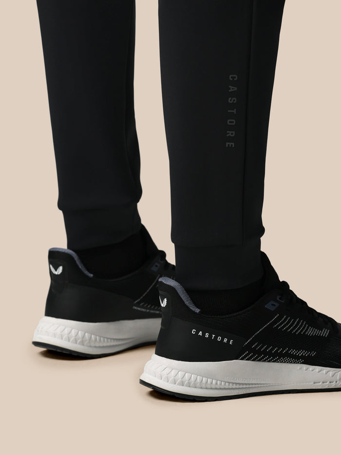 Front view of black Flex Joggers with drawstring waist, zip pockets, and Castore logo on the thigh