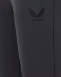 Close-up of the Castore logo embossed on dark fabric of the joggers