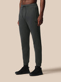 Full-length view of gunmetal Flex Joggers with a drawstring waist zip pockets and Castore logo on the thigh