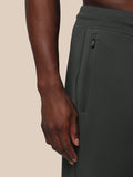 Close-up of the side of gunmetal Flex Joggers showing a zip pocket and Castore logo on the thigh