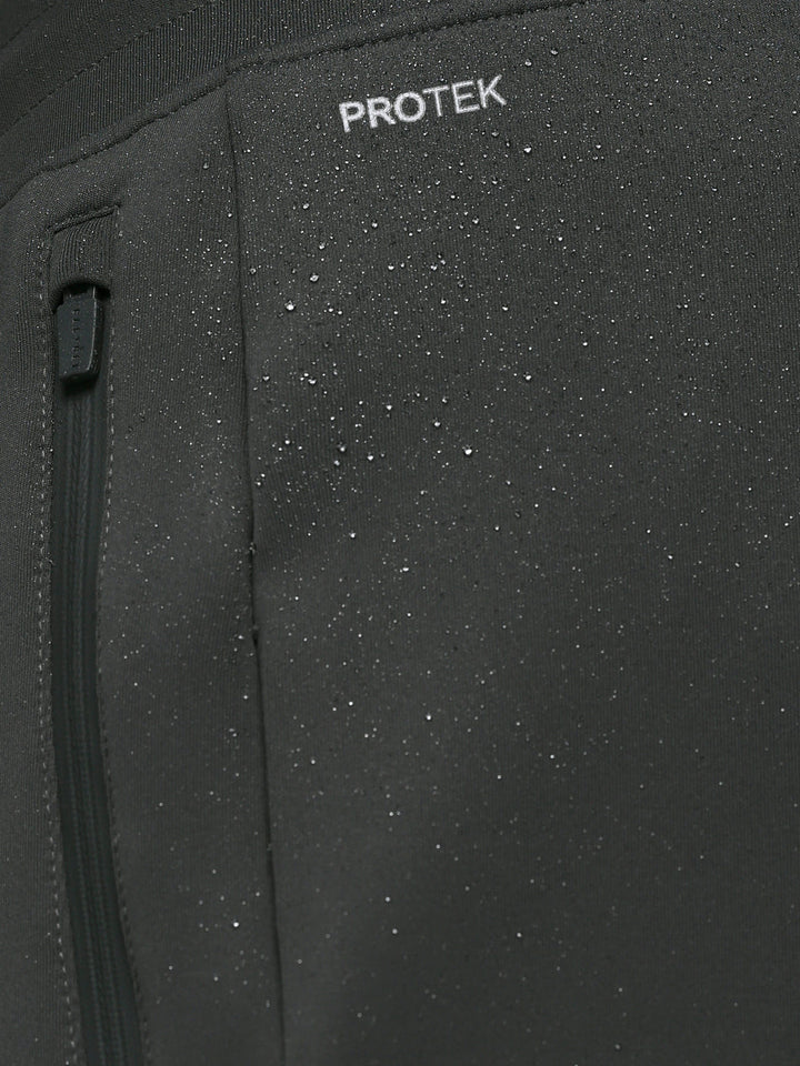 Close-up of dark fabric with water droplets highlighting ProTek water resistance on the joggers.