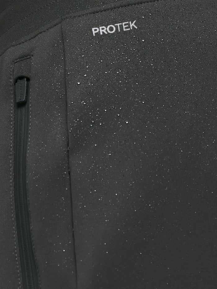 Close-up of dark fabric with water droplets highlighting ProTek water resistance on the joggers.