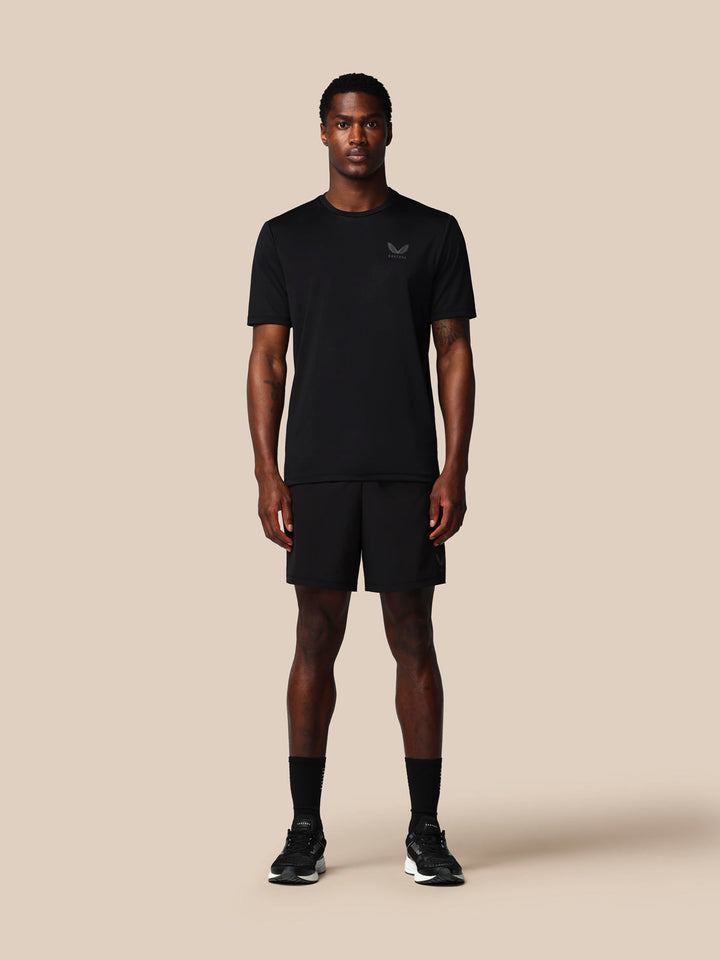 Male model in black Adapt Training Short with ProTek water resistance jacquard waistband and zipped pockets Castore branding on left leg