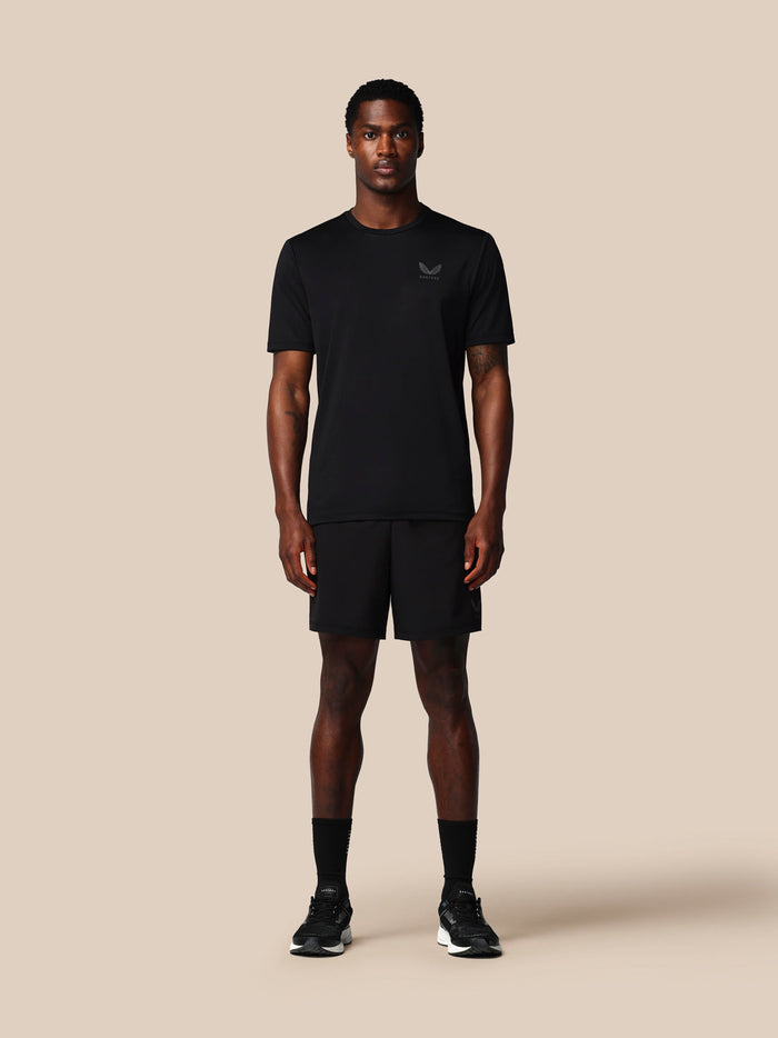 Male model in black Adapt Training Short with ProTek water resistance jacquard waistband and zipped pockets Castore branding on left leg