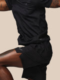 Close-up of model wearing black Adapt Training Short with Castore logo on waistband and left thigh