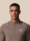 Close up of chest area showing Castore logo with wings on taupe training top