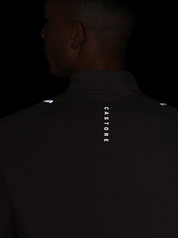 Rear view of the deep taupe Castore Apex Quarter Zip Top showing vertical CASTORE branding down the back