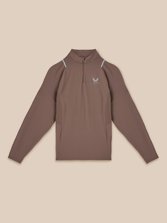 Flat lay of deep taupe Apex Quarter Zip Top with front zipper chest logo and pale blue shoulder accents