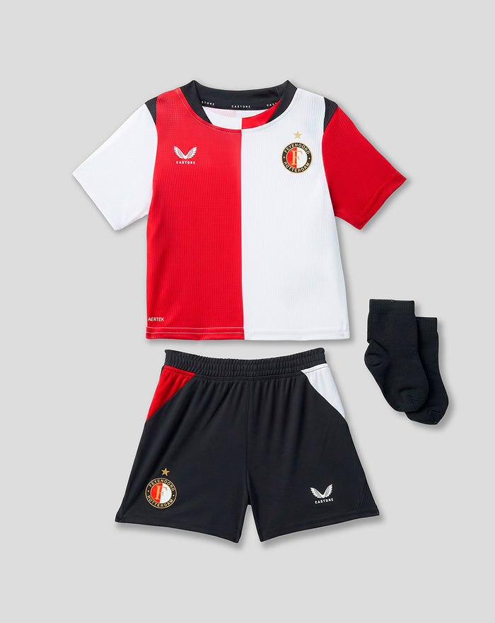 Baby Feyenoord training kit with red and white split shirt, black shorts with crest and Castore logo, and socks.