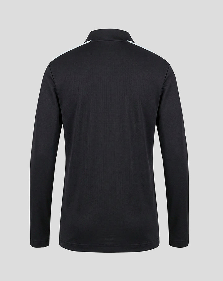 Rear view of a black junior Feyenoord training midlayer jacket with a stand up collar and light blue shoulder panels