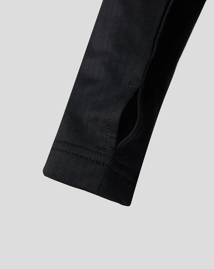 Close up of the black sleeve cuff with a small slit on the junior Feyenoord training midlayer