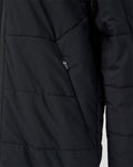 Close-up of black padded Feyenoord junior training jacket with zip pocket.