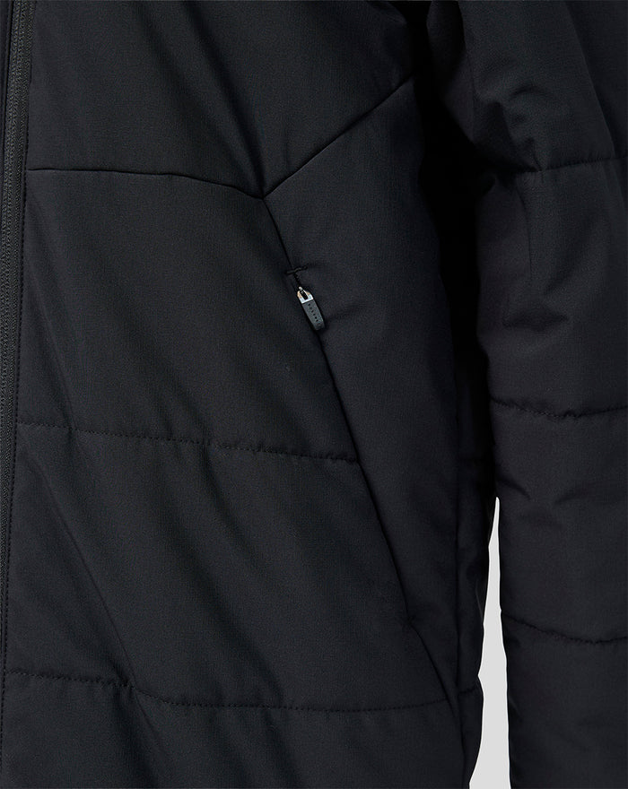 Close-up of black padded Feyenoord junior training jacket with zip pocket.