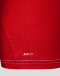 Close up of red Feyenoord jersey fabric with AERTEK branding near the hem.