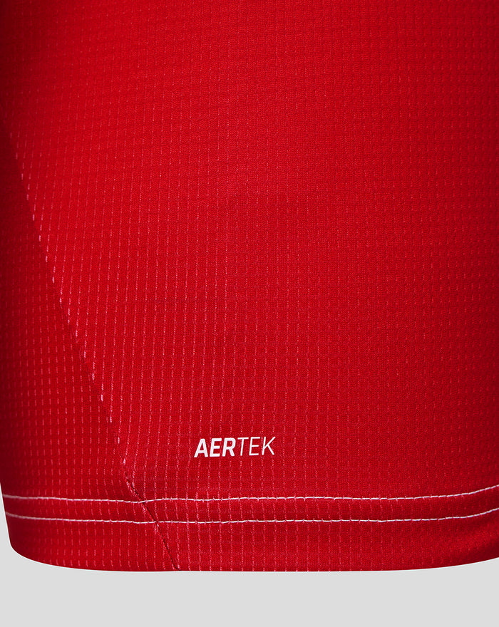 Close up of red Feyenoord jersey fabric with AERTEK branding near the hem.