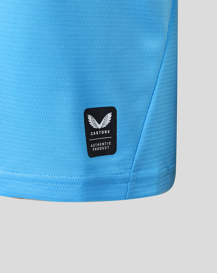 Lower side hem of light blue Feyenoord junior shirt with Castore authentic product patch