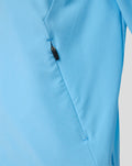 Side view of the light blue Feyenoord junior jacket featuring a zip pocket and stitching.