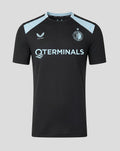Front view of men's Feyenoord Training 2026-2027 Coaches T Shirt with dark body light blue shoulder panels, club crest on left chest and bold sponsor text across the chest