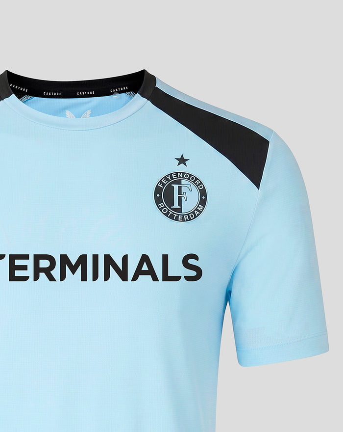 Light blue Feyenoord training shirt with a black shoulder panel and the club crest on the chest, plus a bold sponsor across the front