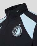 Feyenoord training jacket close up featuring the crest with star above on the chest, Castore logo, and light blue shoulder panel.