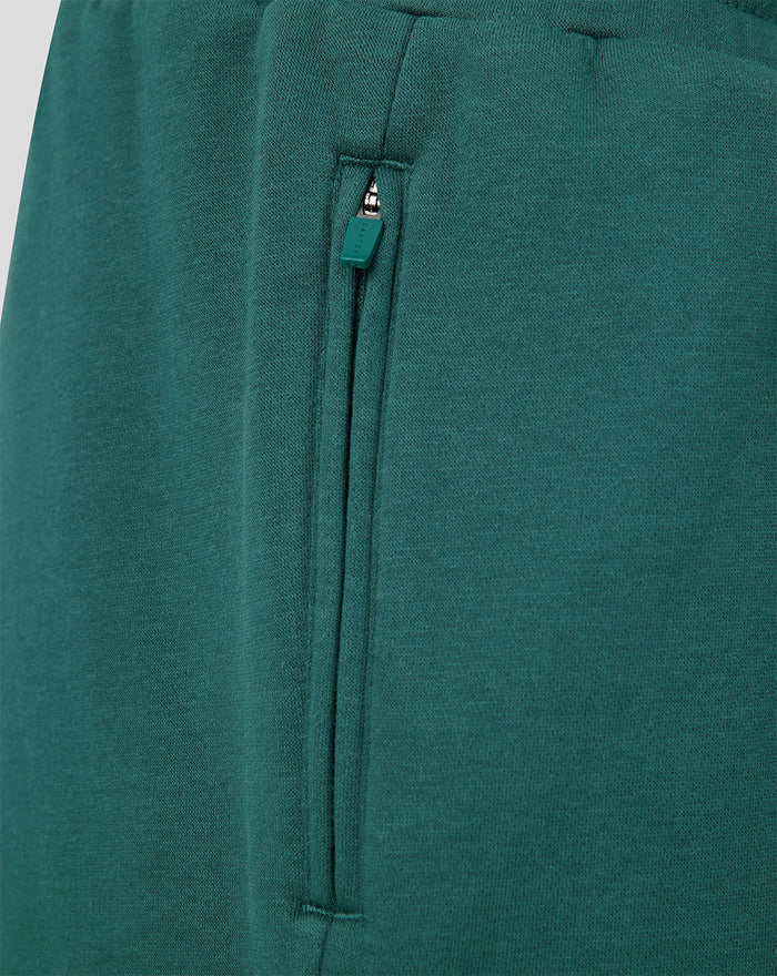 Close view of zipper pocket on green Feyenoord Travel short with teal zipper pull.