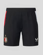 Back view of black Feyenoord home shorts with red side stripe and white panel, displaying the club crest and Castore logo.