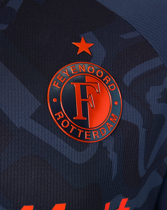 Close-up of the navy shirt badge with the Feyenoord crest and an orange star.