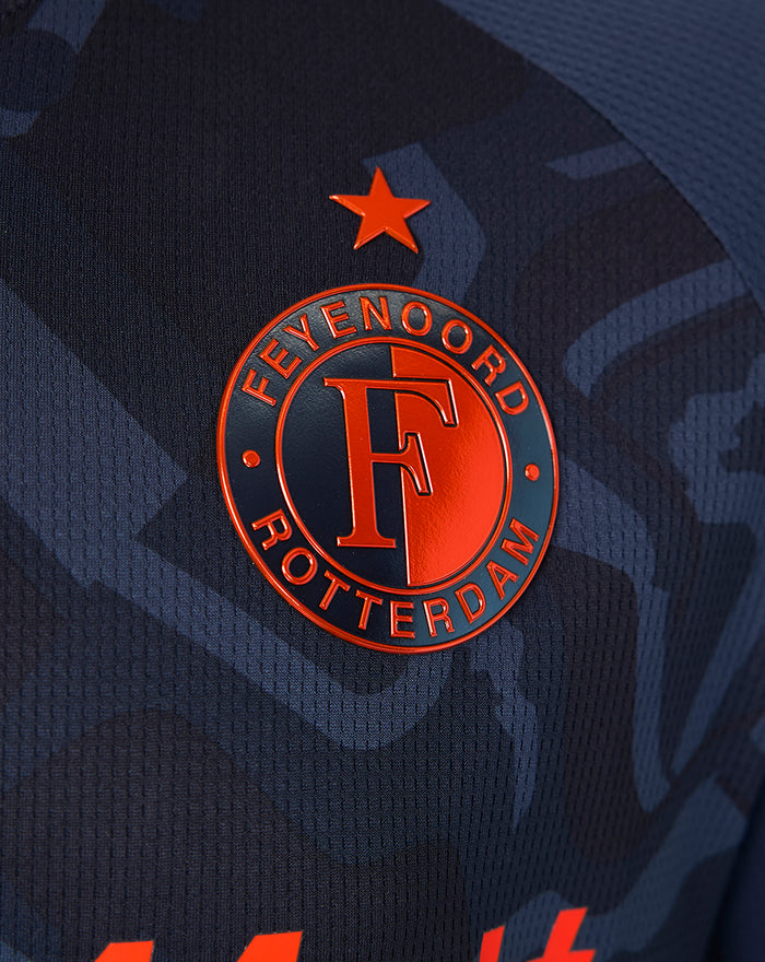 Close-up of the navy shirt badge with the Feyenoord crest and an orange star.