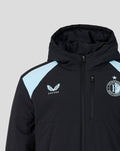Close up of the front upper chest of the black jacket with a hood and light blue shoulder panels and the Feyenoord crest