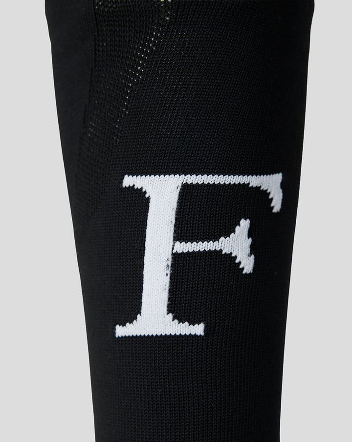 White Feyenoord F logo on black fabric of the home sock as a close up detail