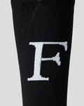 Close up of black Feyenoord sock with a bold white F logo on the shin.