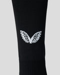 Close up of black junior Feyenoord home sock showing the white Castore logo on the calf