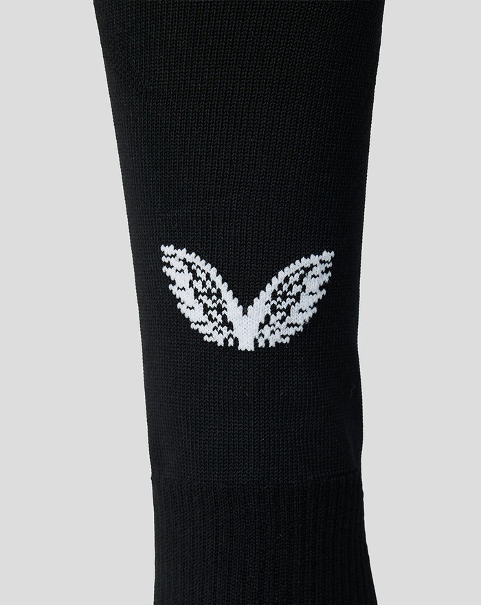 Close up of black junior Feyenoord home sock showing the white Castore logo on the calf