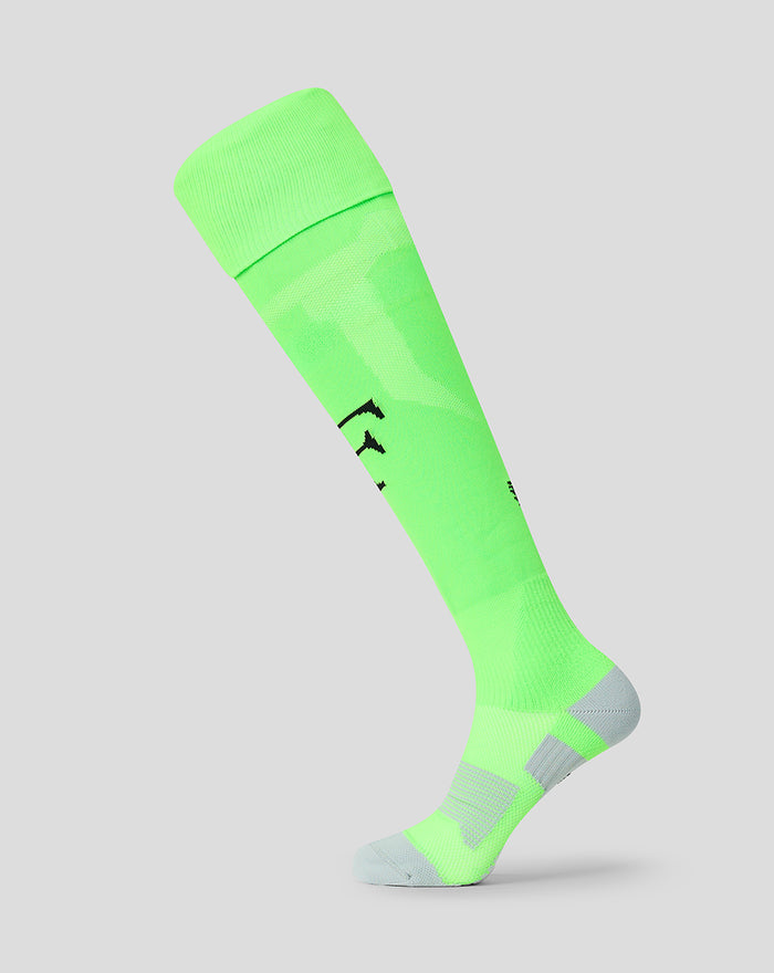Junior Feyenoord keeperskousen in neon groen met Castore logo en Feyenoord F op het scheenbeen