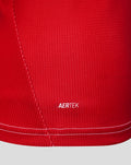 Close up of red Feyenoord women's home shirt fabric with AERTEK branding and a visible seam.