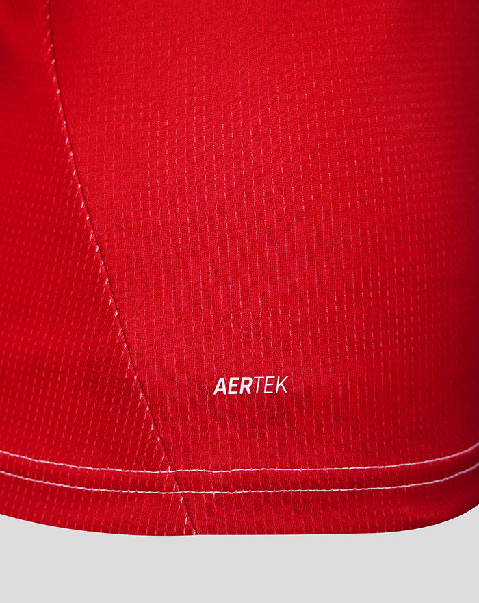 Close up of red Feyenoord women's home shirt fabric with AERTEK branding and a visible seam.