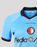 Close-up of the blue away shirt collar with black trim and Castore branding along the neck.