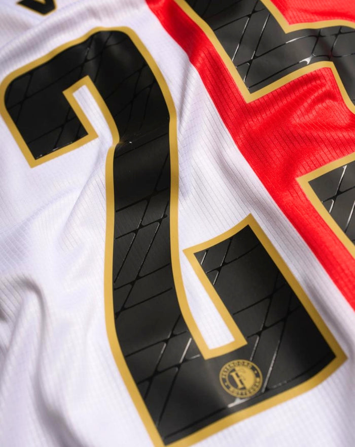 Close up of Feyenoord Pro Home shirt 2025-2026 back details showing a large black number outlined in gold on white fabric