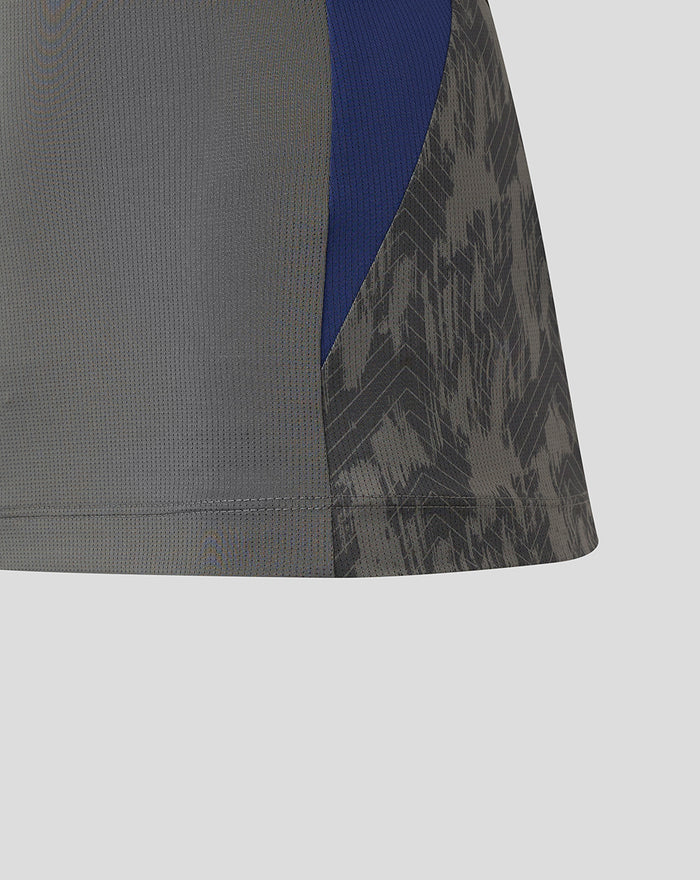 Side view of the Feyenoord training shirt with blue panel and dark patterned sleeve.