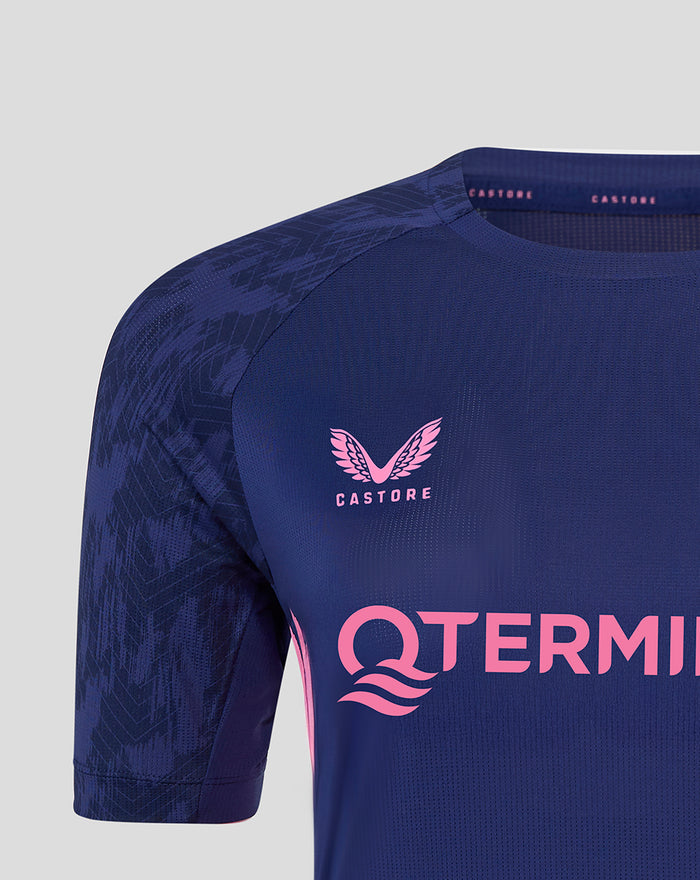 Close up of Feyenoord training T-shirt for women in dark blue fabric with pink sponsor text across chest and Castore and Feyenoord logos on the chest.