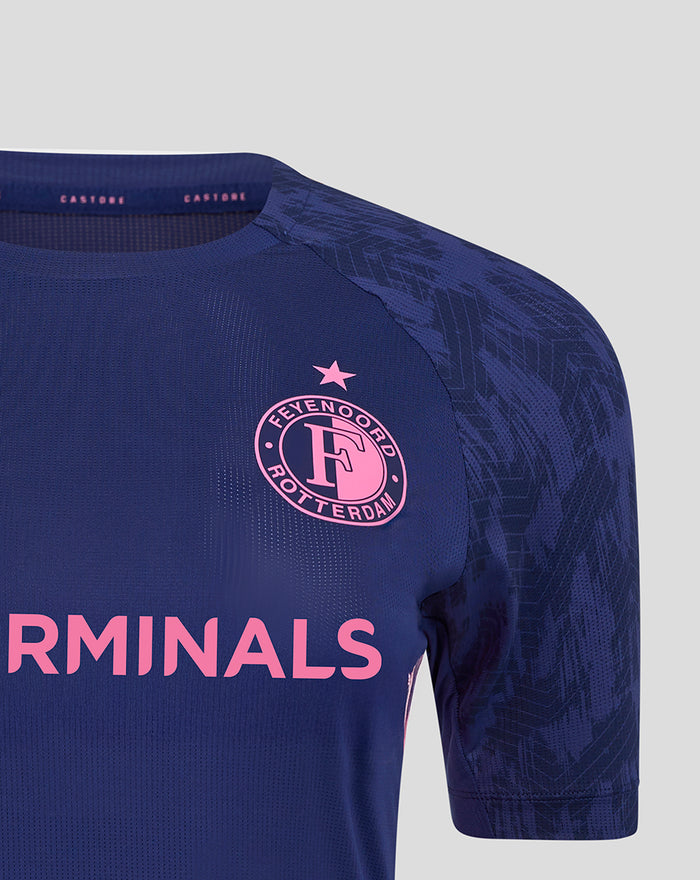 Close up of the left chest showing the Feyenoord crest with a pink star above on navy fabric and bold pink sponsor lettering across the front