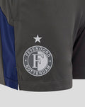 Close-up of the left leg showing the Feyenoord crest and star on dark gray training shorts.