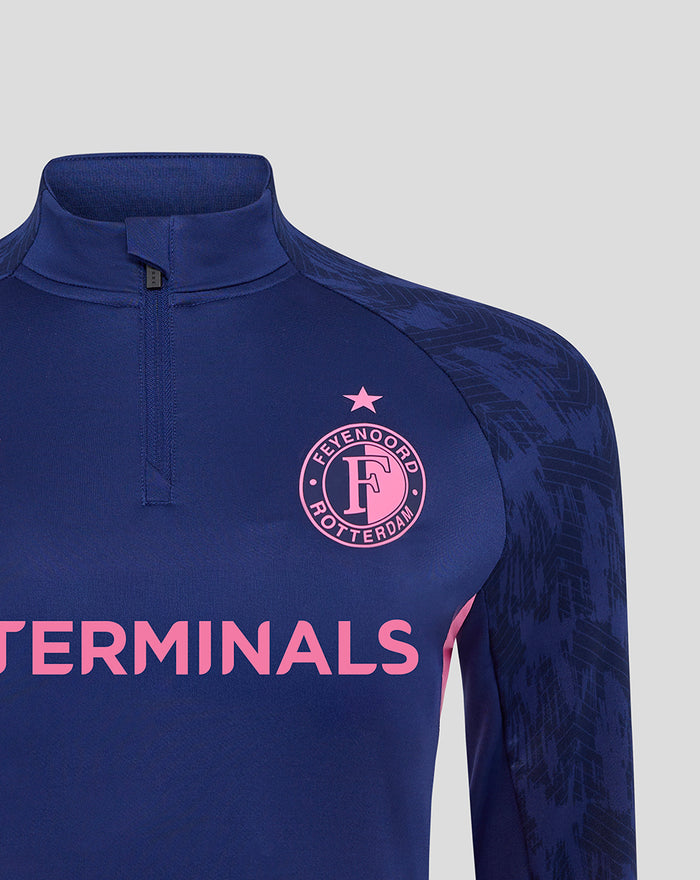 Close up of navy Feyenoord women training midlayer top with pink club crest and Castore logo on the chest