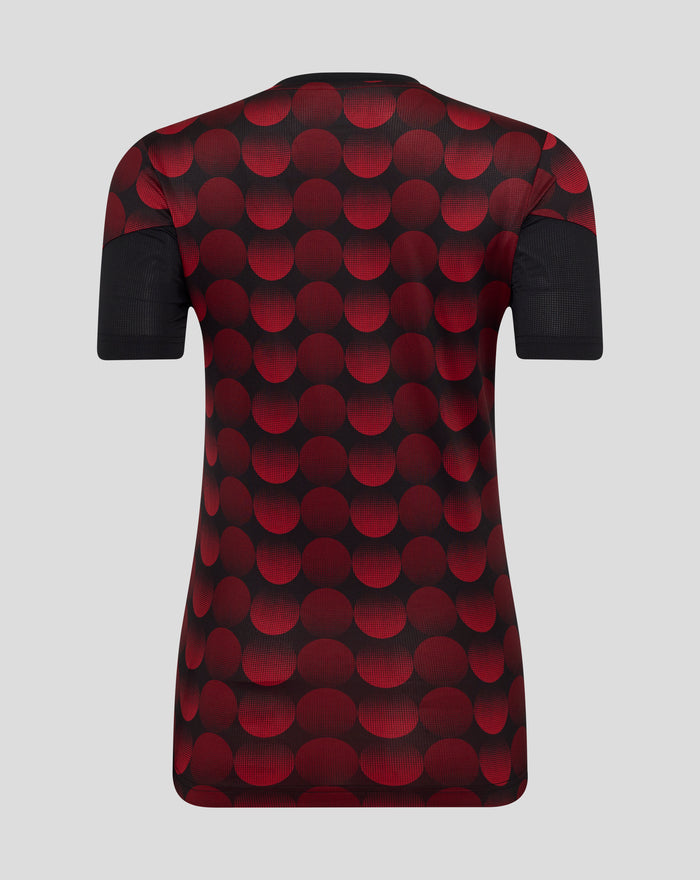 Back view of a women's Feyenoord home matchday T-shirt with a bold red polka dot pattern on black fabric and short sleeves