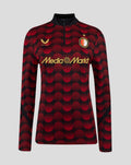 Front view of women's Feyenoord Matchday Midlayer Top with red circular pattern and gold Castore and MediaMarkt logos plus club crest on the chest.