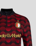 Feyenoord home matchday midlayer top with bold red circle pattern, zipper and crest with MediaMarkt branding.